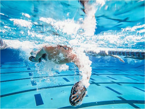 Swimmer performing strength training for power and efficiency